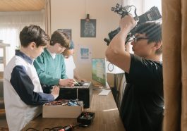 Woman in black shirt holding black and gray machine